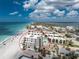 Condo complex with beach access, a communal pool, and palm trees, offering a resort-style living experience at 2792 N Beach Rd # 301, Englewood, FL 34223