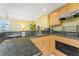 Bright kitchen with granite countertops and wooden cabinetry at 2792 N Beach Rd # 301, Englewood, FL 34223