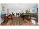 Open concept kitchen featuring stainless steel appliances, hardwood floors, and dining space for entertaining at 2792 N Beach Rd # 301, Englewood, FL 34223