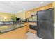 Well-equipped kitchen with wooden cabinets and black appliances at 2792 N Beach Rd # 301, Englewood, FL 34223