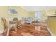 Living space and dining area features wood floors and shutters at 2792 N Beach Rd # 301, Englewood, FL 34223
