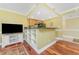 Open living space with TV, built-in shelving and wood floors at 2792 N Beach Rd # 301, Englewood, FL 34223