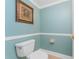 Powder room with wainscoting features neutral walls and tile flooring at 2792 N Beach Rd # 301, Englewood, FL 34223