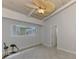 Bright bedroom with tile flooring, a ceiling fan, a window view, and two decorative bird statues at 2980 N Beach Rd # Gv16, Englewood, FL 34223