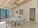 Cozy dining area with tile flooring, wood-paneled ceiling, and sliding glass doors to the outdoor area at 2980 N Beach Rd # Gv16, Englewood, FL 34223