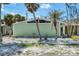 Charming home exterior with a green facade, accented by tropical palm trees and white stone landscaping at 2980 N Beach Rd # Gv16, Englewood, FL 34223