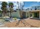 Exterior of home with gravel driveway, lawn, palm trees, angular roof, and carport at 2980 N Beach Rd # Gv16, Englewood, FL 34223