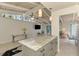 Gourmet kitchen featuring a large island, pendant lighting, stainless steel appliances, and an adjacent living area at 2980 N Beach Rd # Gv16, Englewood, FL 34223