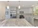 Updated kitchen features stainless appliances, gray cabinetry, and granite countertops at 2980 N Beach Rd # Gv16, Englewood, FL 34223