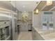 Charming kitchen features gray cabinets, stainless appliances, granite counters and beach-themed window at 2980 N Beach Rd # Gv16, Englewood, FL 34223