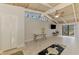 Bright living room with vaulted ceilings, neutral tile flooring, and sliding glass doors at 2980 N Beach Rd # Gv16, Englewood, FL 34223