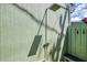 Outdoor shower featuring a traditional shower head and a convenient bench, set against a green backdrop at 2980 N Beach Rd # Gv16, Englewood, FL 34223