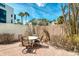 Private patio area with a table and chairs, providing an outdoor dining space surrounded by lush landscaping at 2980 N Beach Rd # Gv16, Englewood, FL 34223