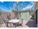 Paver patio area featuring an outdoor dining set, lush greenery, and a privacy fence at 2980 N Beach Rd # Gv16, Englewood, FL 34223