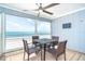 Screened balcony with dining set and stunning beachfront views at 301 S Gulf Blvd # 419, Placida, FL 33946