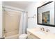 Cozy bathroom featuring a shower-tub combo and a stylish sink with neutral countertops at 301 S Gulf Blvd # 419, Placida, FL 33946