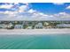 Beachfront neighborhood featuring colorful houses lining a pristine white sandy beach at 301 S Gulf Blvd # 419, Placida, FL 33946