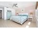 Bright bedroom featuring a queen bed, coastal decor, and hardwood flooring at 301 S Gulf Blvd # 419, Placida, FL 33946