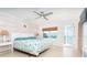 Bedroom featuring a queen bed, coastal decor, and view to the deck at 301 S Gulf Blvd # 419, Placida, FL 33946