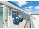 Outdoor deck with two blue Adirondack chairs overlooking the beach at 301 S Gulf Blvd # 419, Placida, FL 33946