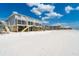 Beach house featuring an elevated deck and beach views on a clear day at 301 S Gulf Blvd # 419, Placida, FL 33946