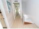 Hallway leading to bedrooms and bathrooms with wood-look floors at 301 S Gulf Blvd # 419, Placida, FL 33946
