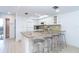 Modern kitchen featuring granite countertops, stainless steel stools, and bright lighting at 301 S Gulf Blvd # 419, Placida, FL 33946