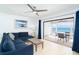 Bright living room features blue sectional and screened balcony with ocean view at 301 S Gulf Blvd # 419, Placida, FL 33946