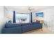 Bright living room features blue sectional and balcony with ocean view at 301 S Gulf Blvd # 419, Placida, FL 33946