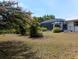 Enclosed pool and manicured backyard with lush plants at 3278 Cabaret St, Port Charlotte, FL 33948