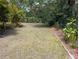 Spacious backyard with green grass and well-maintained landscaping, perfect for outdoor activities at 3278 Cabaret St, Port Charlotte, FL 33948