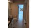 Bright bathroom with a bathtub, toilet, and view to another room through an open door at 3278 Cabaret St, Port Charlotte, FL 33948