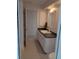 Bathroom featuring a white vanity with black countertops and white cabinets at 3278 Cabaret St, Port Charlotte, FL 33948