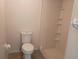 Bathroom featuring a standard toilet, tiled floors and walk-in shower with shelves at 3278 Cabaret St, Port Charlotte, FL 33948