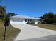 Charming single Gathering home features a spacious driveway and an attached two-car garage at 3278 Cabaret St, Port Charlotte, FL 33948