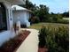 Landscaped front yard with a well-manicured lawn and sidewalk to the front door at 3278 Cabaret St, Port Charlotte, FL 33948