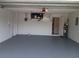 Spacious garage with painted floors, access doors, and utility hookups at 3278 Cabaret St, Port Charlotte, FL 33948