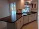 Bright kitchen featuring white cabinetry, modern appliances, and a view of the pool area at 3278 Cabaret St, Port Charlotte, FL 33948