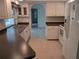 Well-lit kitchen with sleek countertops, white appliances, and ample cabinet space at 3278 Cabaret St, Port Charlotte, FL 33948