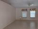 Bright living room features neutral paint, ceramic tile flooring, and natural light from two windows at 3278 Cabaret St, Port Charlotte, FL 33948