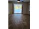 Open floorplan living room with floor to ceiling doors opening to a screened pool at 3278 Cabaret St, Port Charlotte, FL 33948