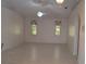 Open living room with neutral paint, ceramic tile flooring, and views of natural light at 3278 Cabaret St, Port Charlotte, FL 33948