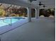 Screened lanai with access to a refreshing in-ground pool surrounded by lush greenery at 3278 Cabaret St, Port Charlotte, FL 33948
