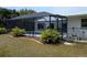 View of the pool enclosure from the backyard at 3278 Cabaret St, Port Charlotte, FL 33948