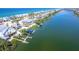 Aerial view of a charming beach home with a dock, nestled between the Gulf and a tranquil canal at 342 S Gulf Blvd, Placida, FL 33946