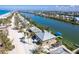 Picturesque aerial view of a beach home on a canal, showcasing its coastal setting and neighborhood at 342 S Gulf Blvd, Placida, FL 33946