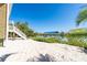 Sandy backyard with a dock and lift provides access to waterfront activities at 342 S Gulf Blvd, Placida, FL 33946