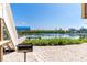 Backyard with BBQ grill and a dock with a boat lift for water access at 342 S Gulf Blvd, Placida, FL 33946