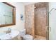 Tiled bathroom features a modern shower, a vanity sink, and neutral-toned decor to provide a clean and pleasant experience at 342 S Gulf Blvd, Placida, FL 33946