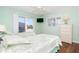 Charming bedroom featuring dual beds, balcony access, and a light green color scheme to accentuate a bright and beachy theme at 342 S Gulf Blvd, Placida, FL 33946